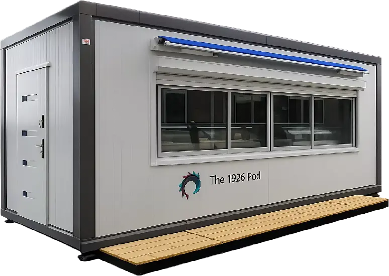 Grey portable modular unit branded The 1926 Pod with roller blind, wide panoramic window, solid side door and timber deck ramp
