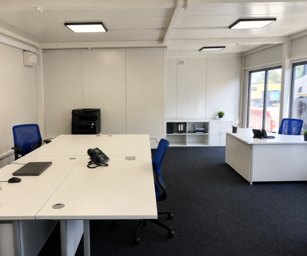 Open-plan modular office interior fitted with desks, monitors, office chairs and wall-mounted air conditioning Emma
