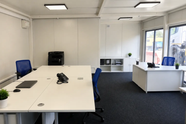 Open-plan modular office interior fitted with desks, monitors, office chairs Emma