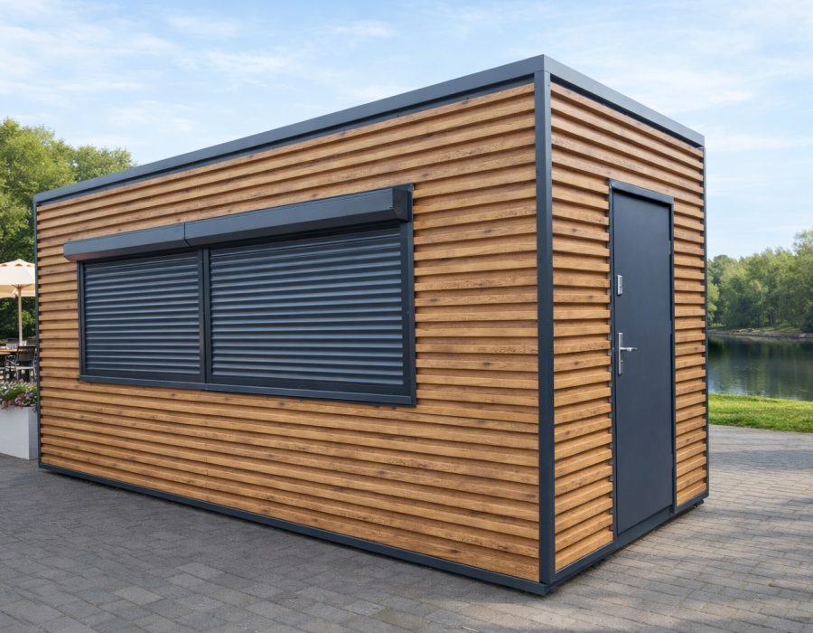 Compact portable kiosk with horizontal timber cladding, anthracite roller shutters over serving window and side access door beside a lake