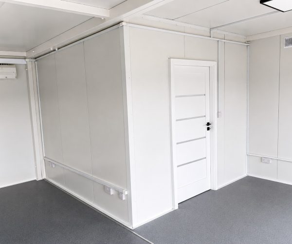 Open-plan modular office interior fitted with desks, monitors, office chairs Emma 2