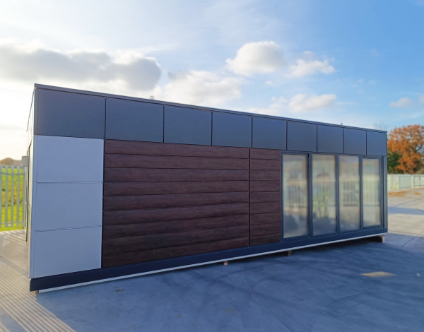 Modular office unit with grey and white panel cladding, wood-effect horizontal boards, and sliding glazed doors